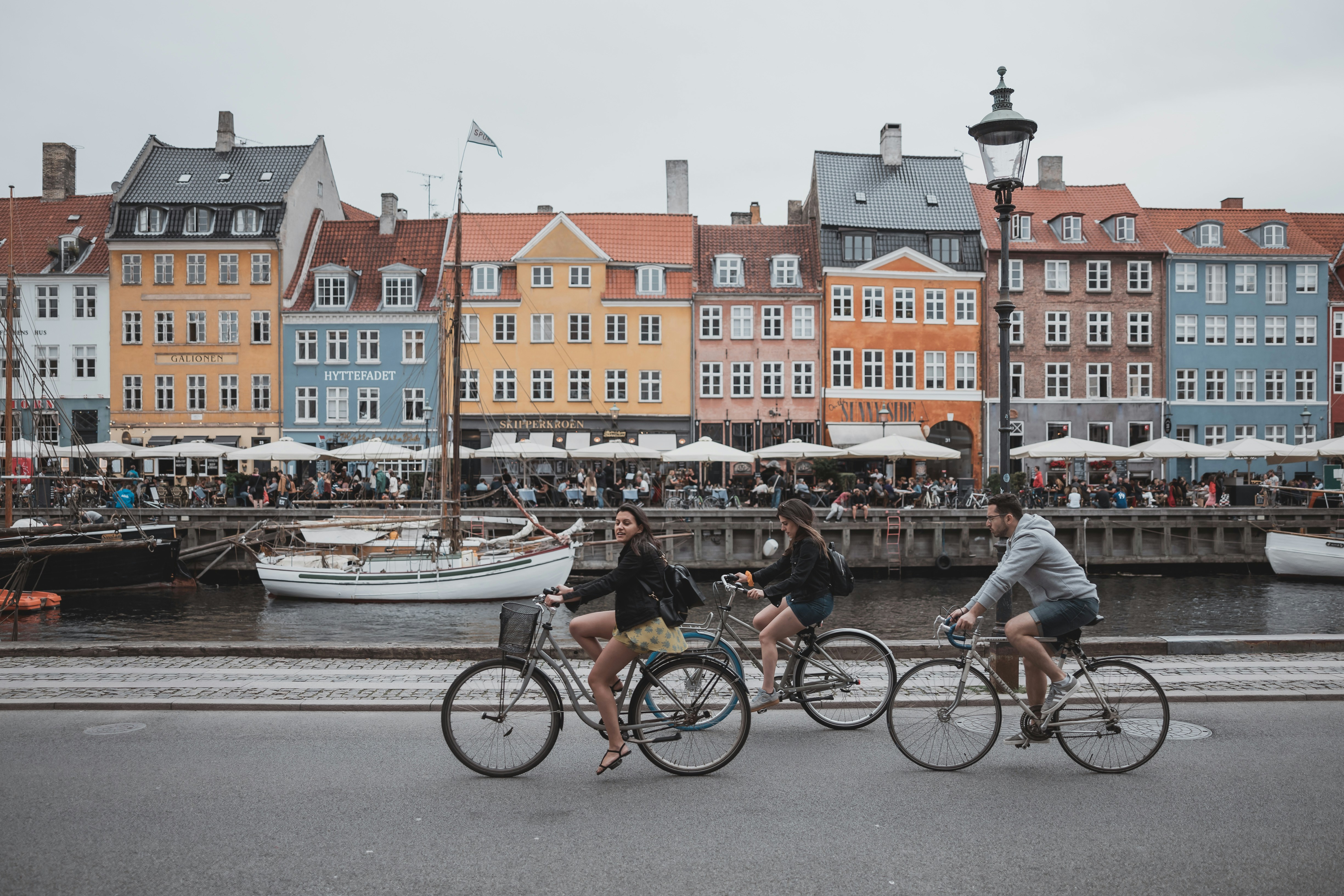 Cyclists passing Nyhavn in Copenhagen